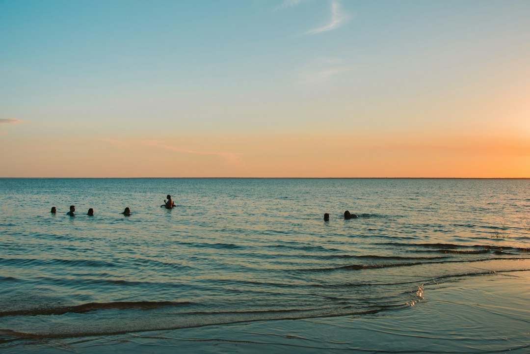 People swimming in the Tapajós River at sunset in Alter do Chão, Pará